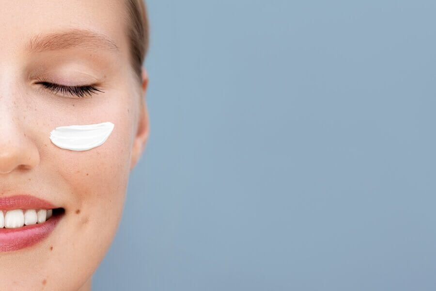 Skinimalism: Junge Frau mit Creme auf der Wange